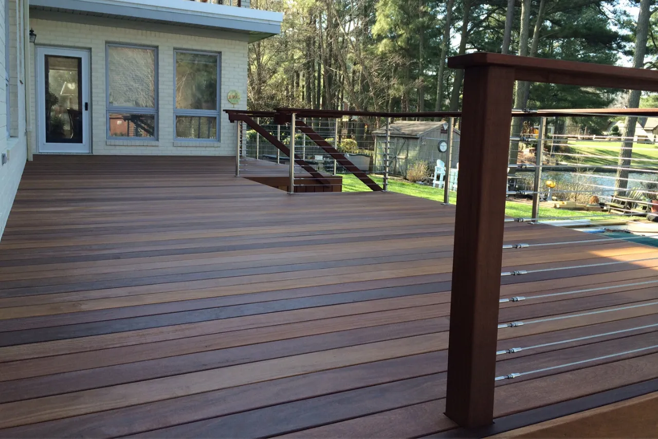 High-end hardwood deck with a stainless cable railing and mahogany posts